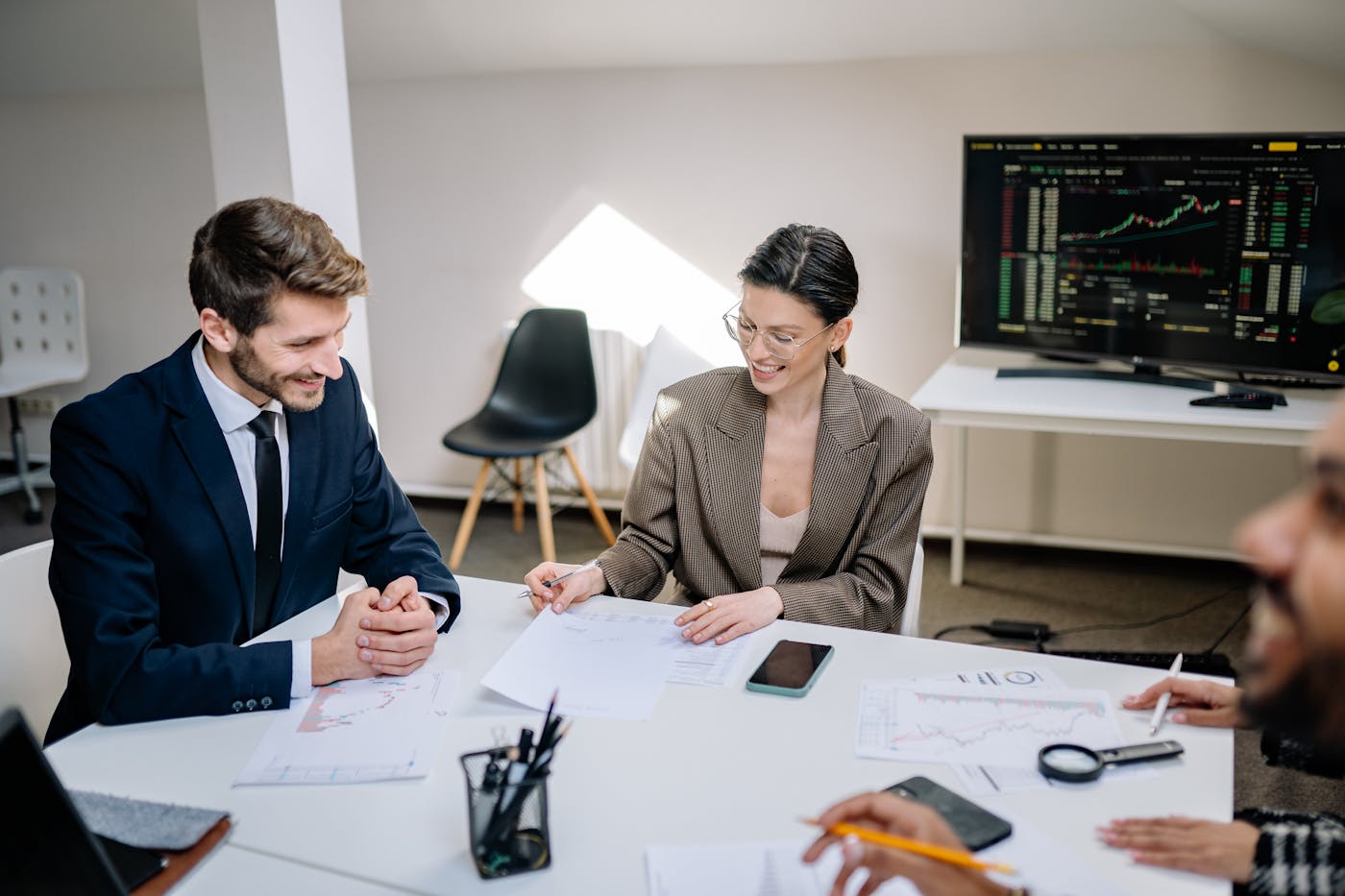 Corporate professionals reviewing charts and documents during a risk-focused meeting.
